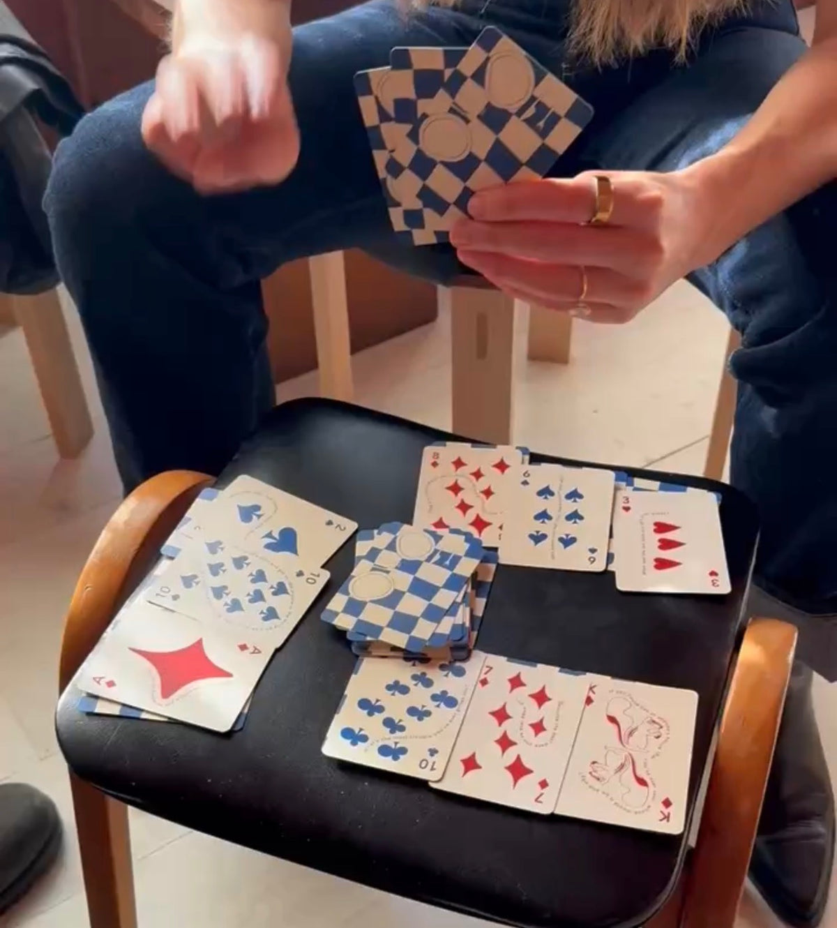 Hands playing CANDID cards