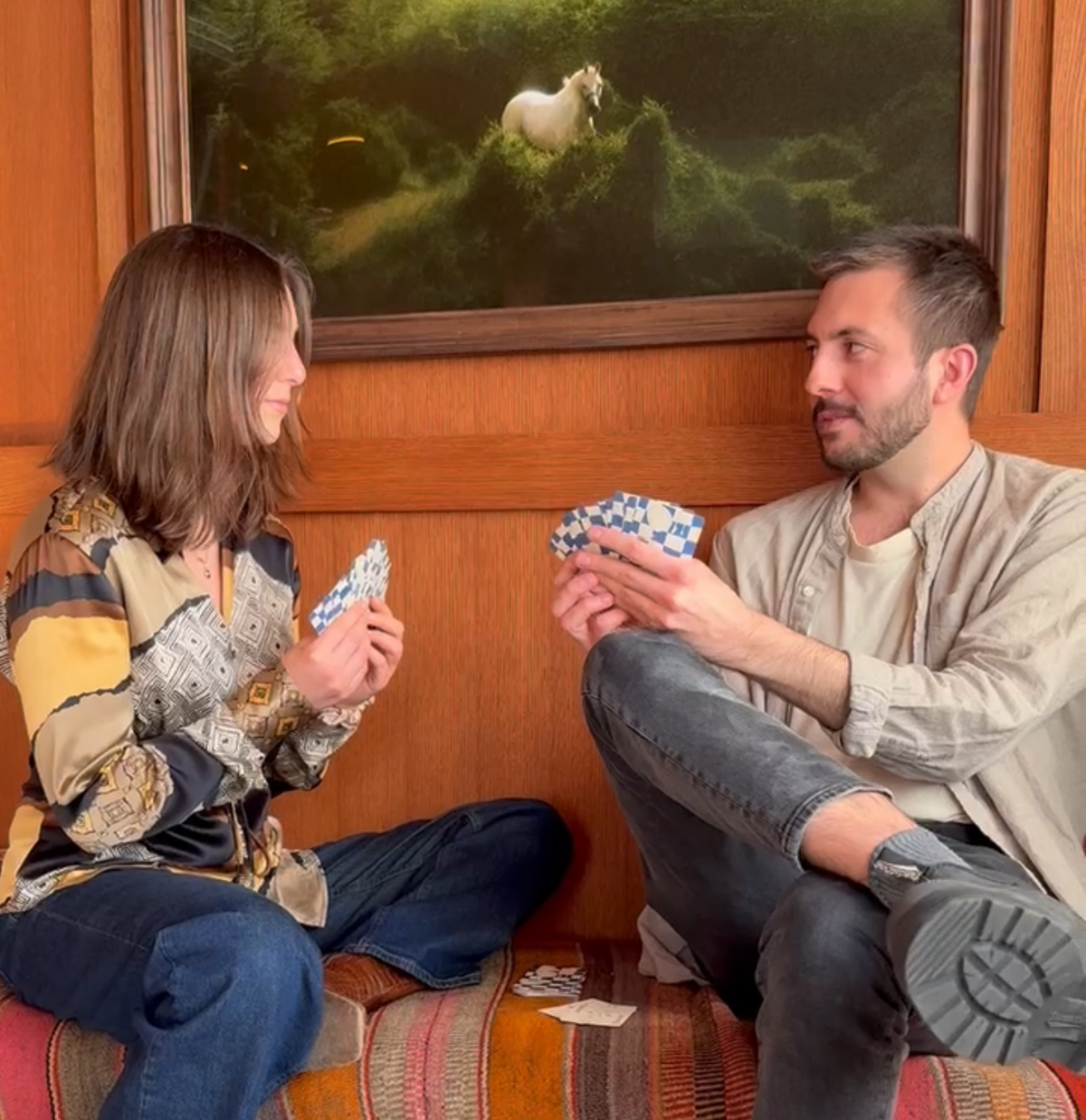 A couple playing CANDID cards