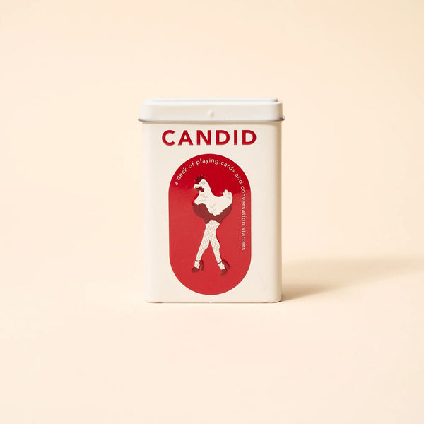 CANDID tin standing on a cream background